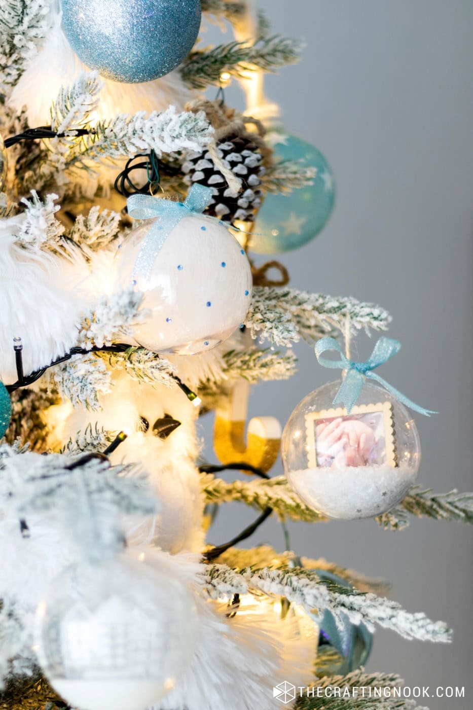 Side view of the Rhinestone Christmas Ornaments filled with feathers hanging on the tree