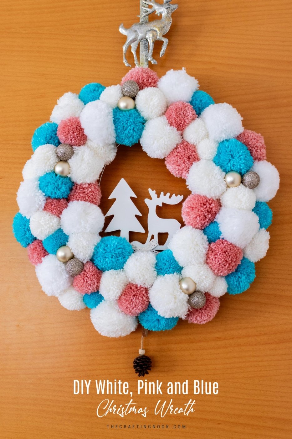 DIY White, Pink and Blue Pompom Wreath for Christmas hanging on the door. Feature Image with Title text overlay