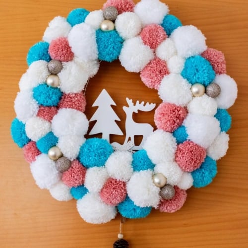 DIY White, Pink and Blue Pompom Wreath for Christmas hanging on the door. Feature Image