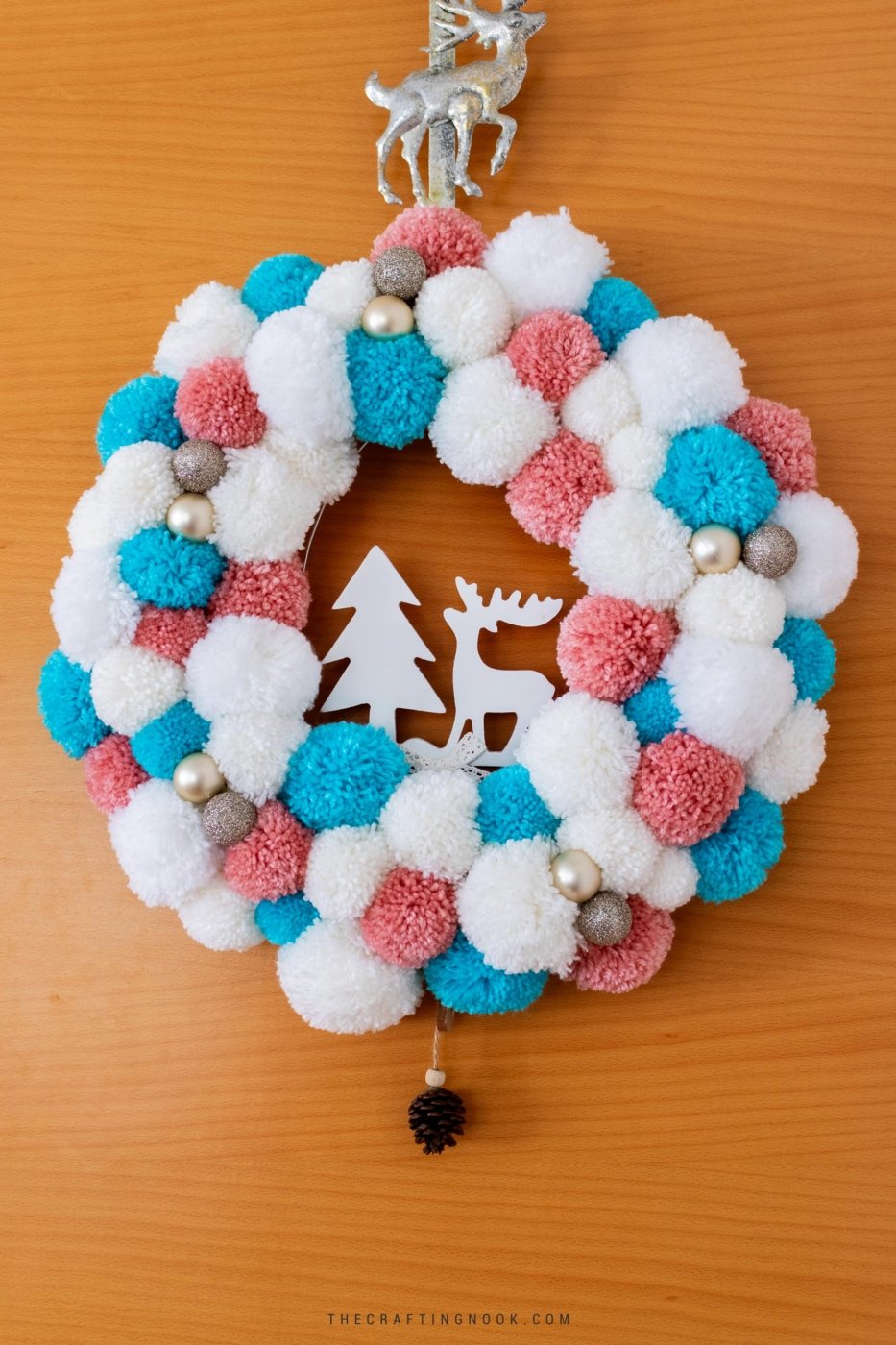 DIY White, Pink and Blue Pompom Wreath for Christmas hanging on the door. Feature Image