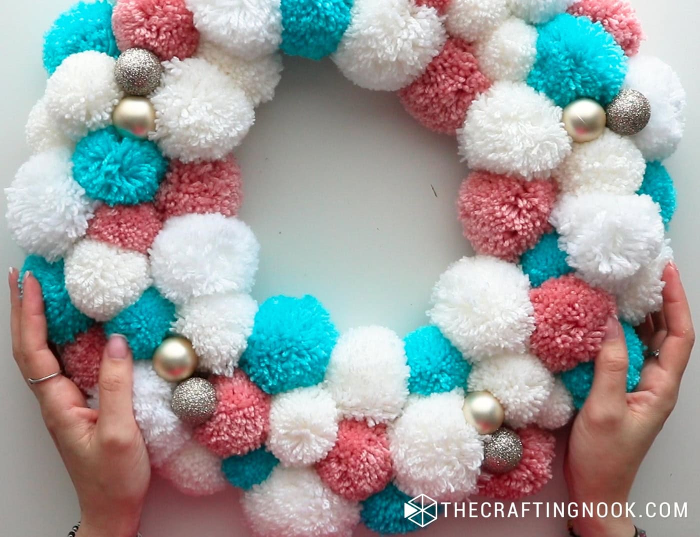 close top image of the pom pom garland with the ornaments placed in the chosen places
