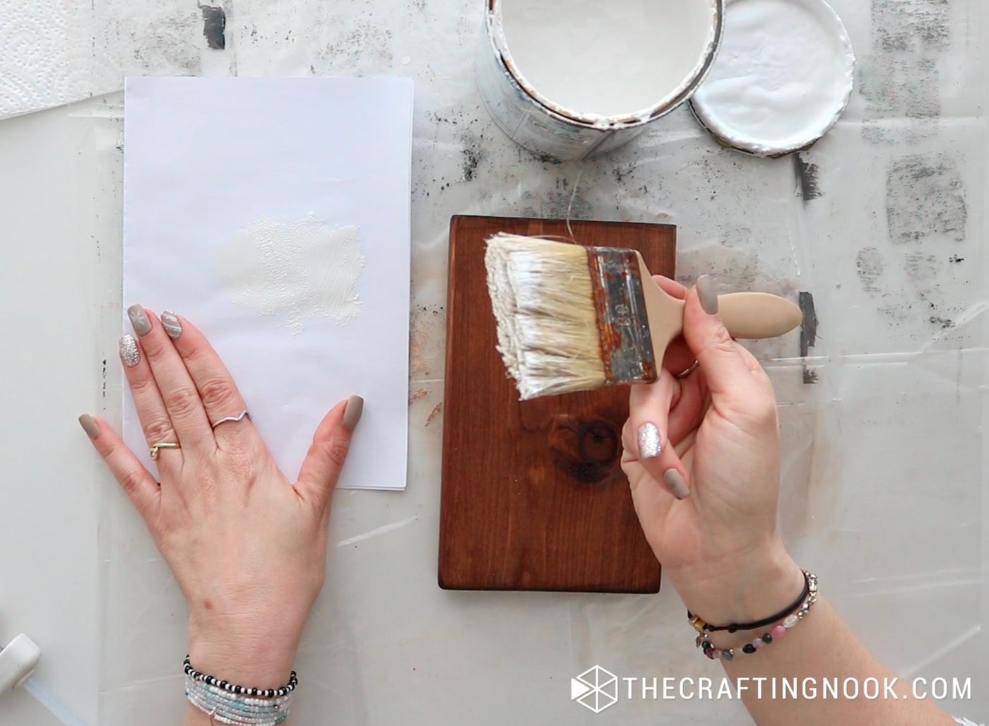 Dabbing white paint onto paper to prepare the dry-brush.