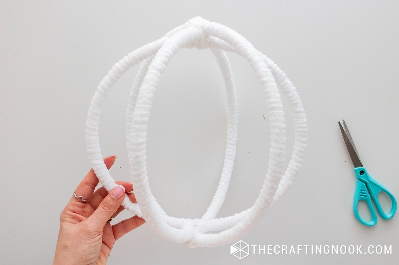 The full spherical frame completed, with all three hoops wrapped in soft white chenille yarn.