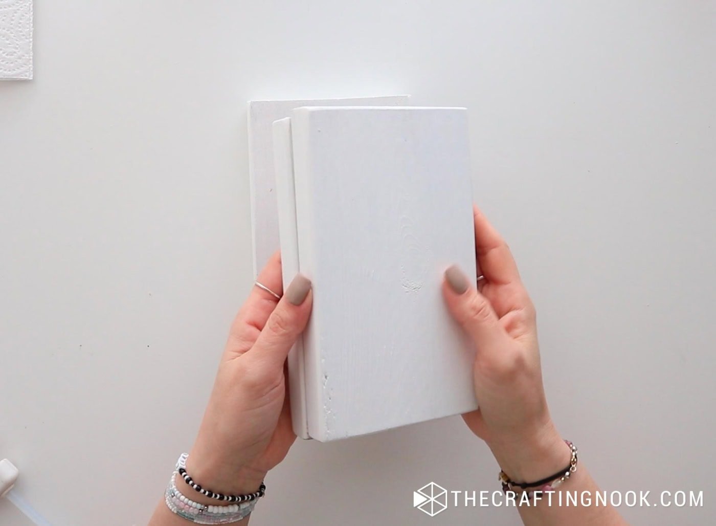 Two painted wood blocks stacked together showing the white finish.