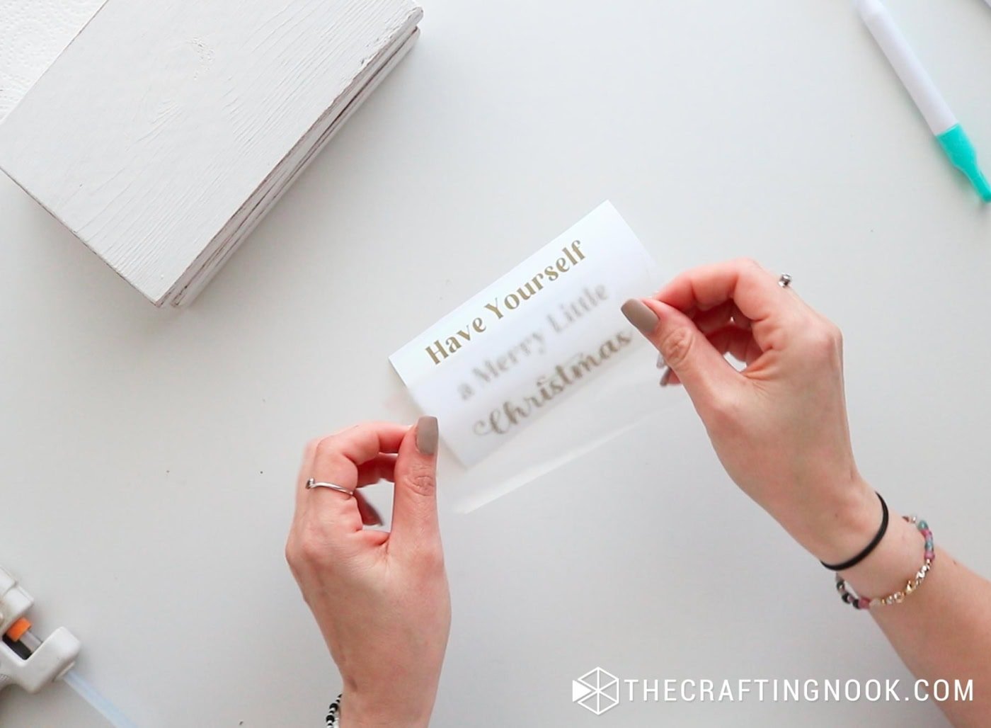 Applying transfer tape over the vinyl text.