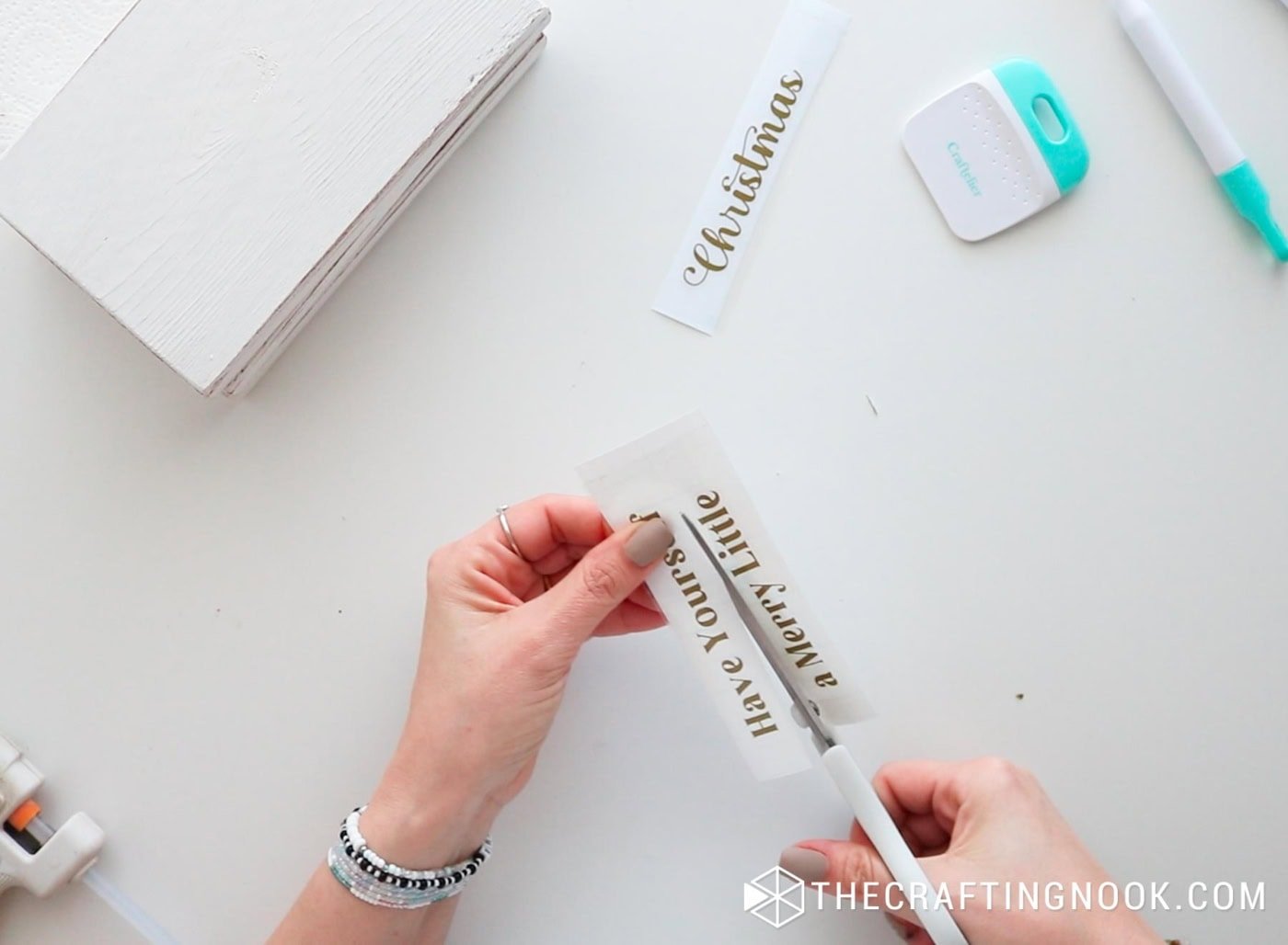 Cutting the vinyl phrases apart with scissors.