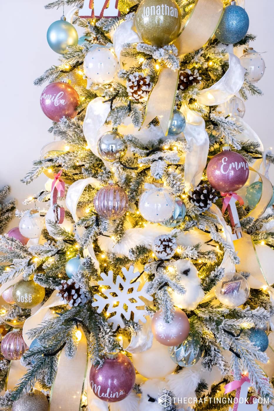 White fluffy ribbon woven into the flocked tree, adding a snowy texture to the decorations.