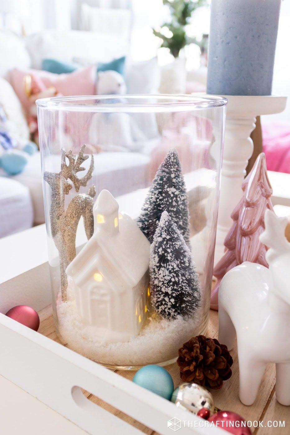 Wide shot of the finished jar winter scene displayed with Christmas decor pieces.