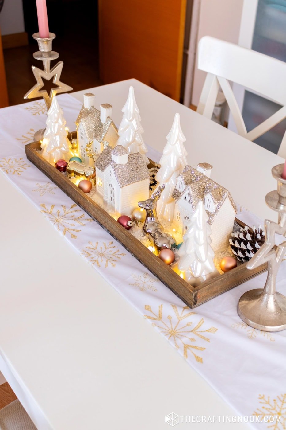 Completed winter village table centerpiece displayed on a dining table runner