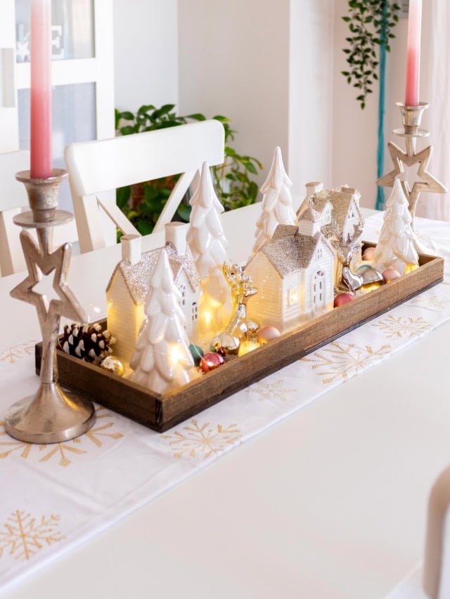 Side view of the winter village tray centerpiece with ceramic houses, trees, and fairy lights. Feature image.