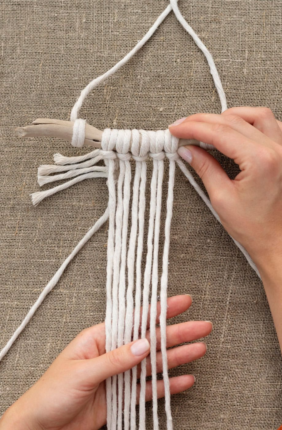 Beginner-friendly macrame wall hanging with cords and knots for home decor.