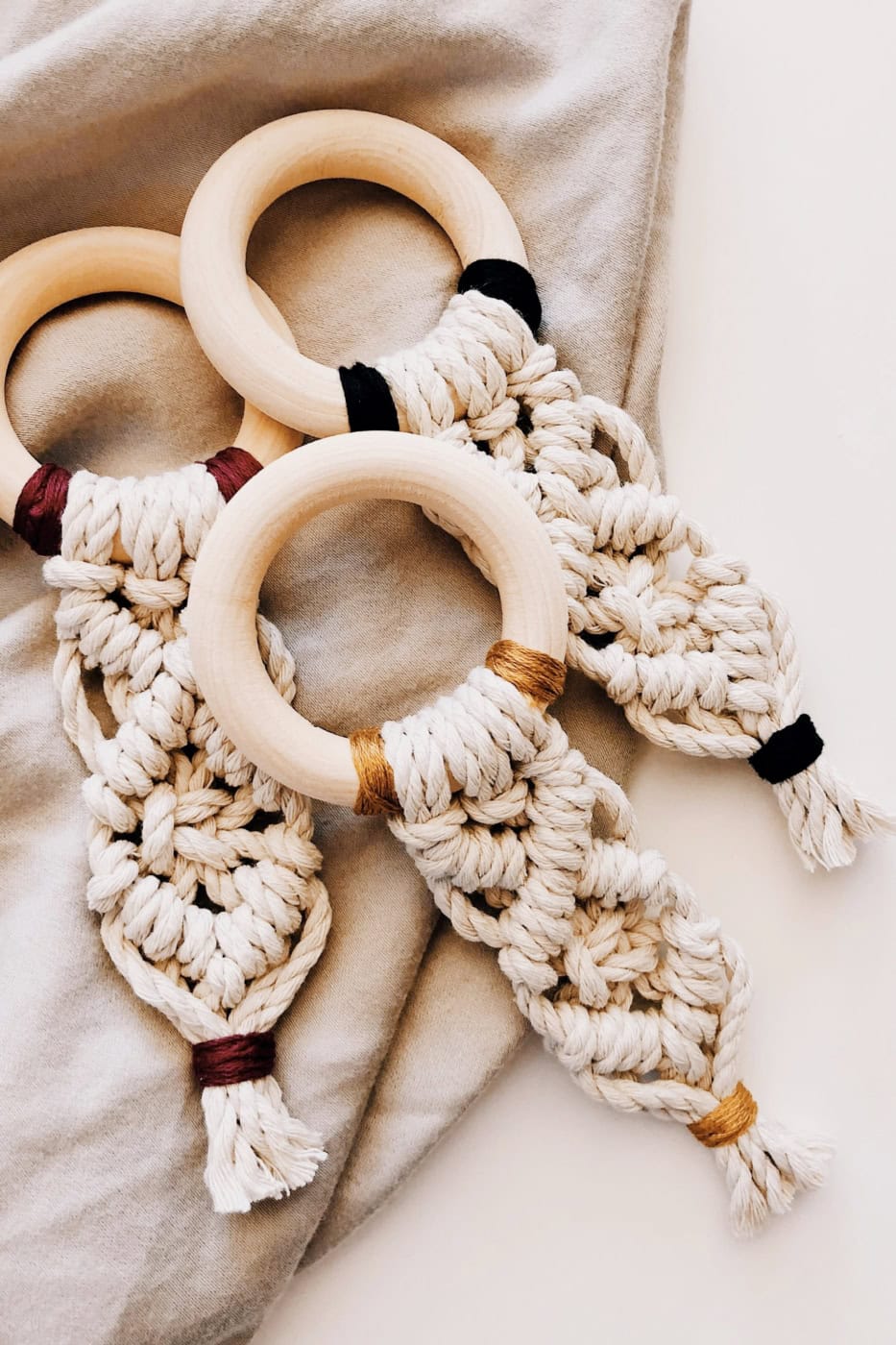 Wooden rings with knotted cords for macrame beginners, showcasing basic knotting supplies.
