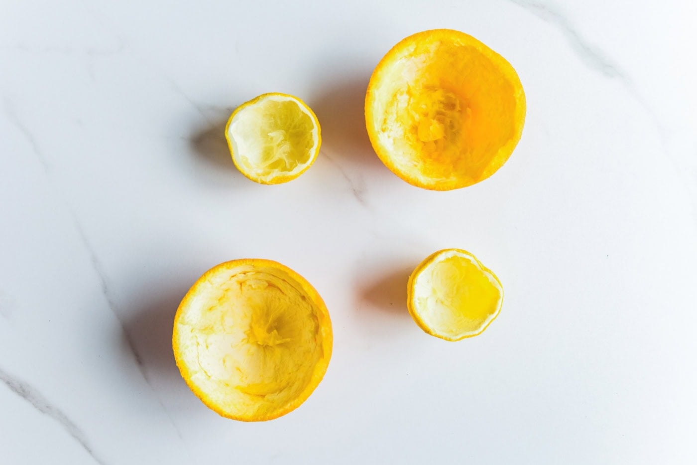Hollowed orange and lemon halves prepared to use as natural candle containers.