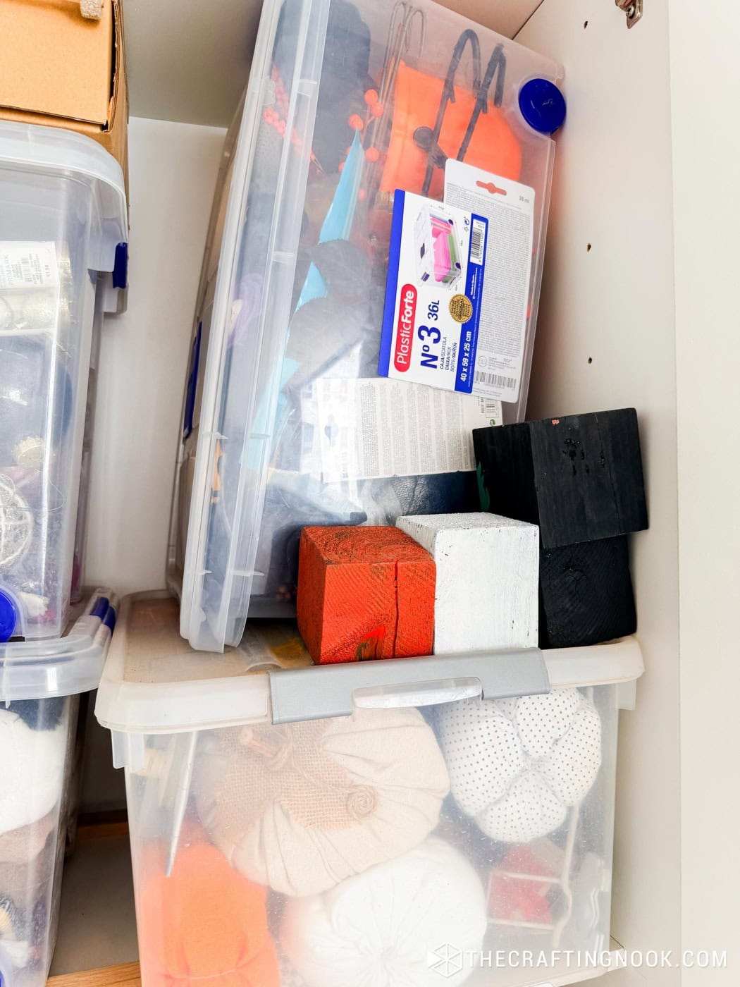 Craft closet storage bins with fabric pumpkins and painted wood blocks