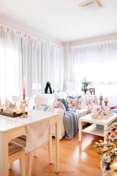 View from the dining table to the living room, with a pastel Christmas coffee table and sofa